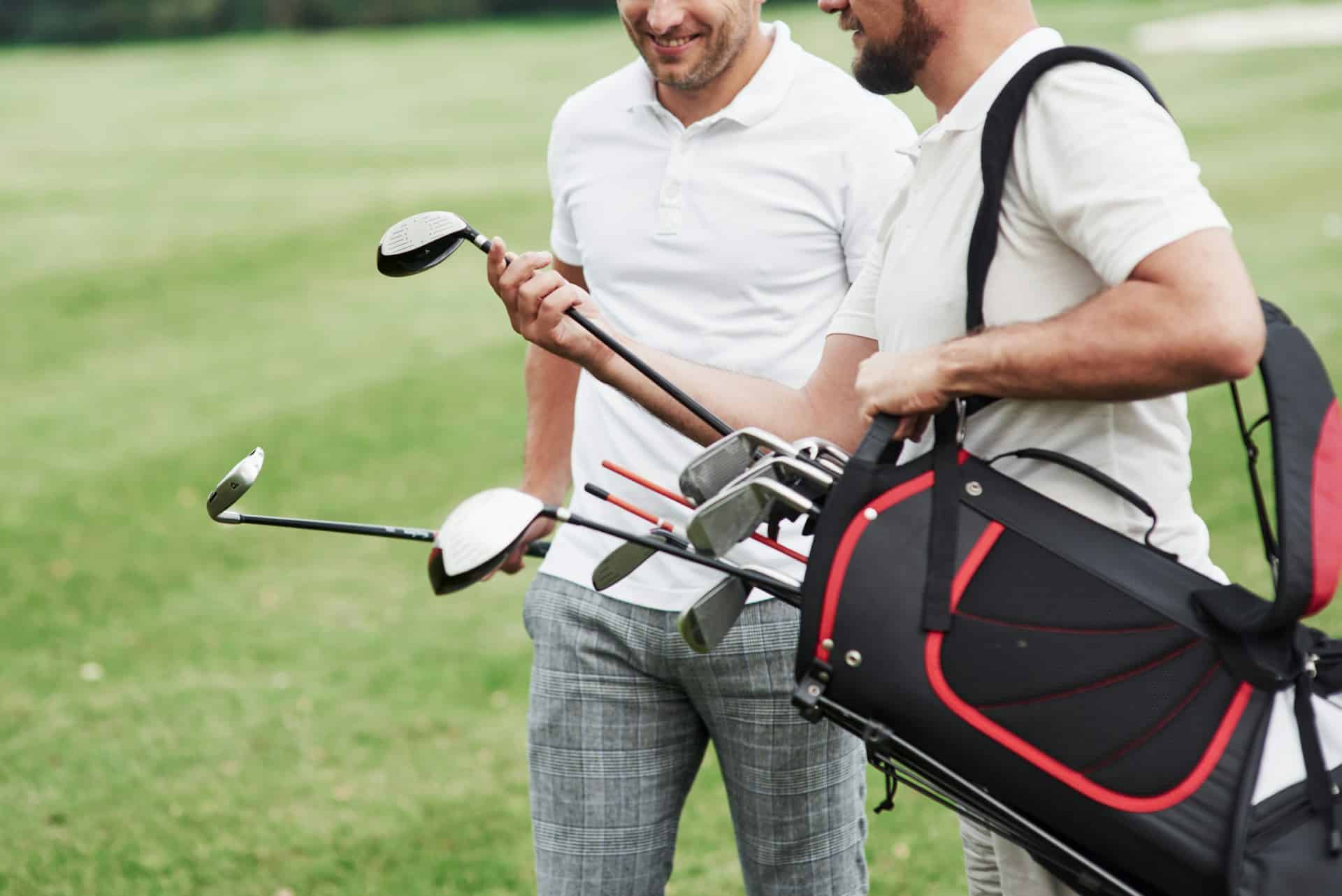 two-friends-on-the-sports-field-with-golf-equipment